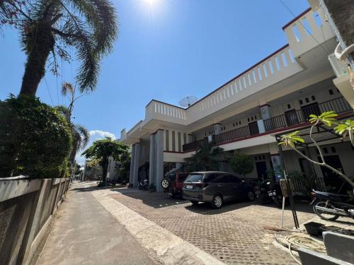 a car parked in front of a building at Hotel Century Pangandaran in Pangandaran