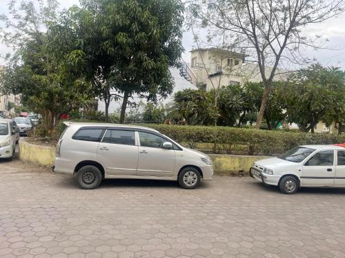 a group of cars parked in a parking lot at Charming 2 BR house in a secure gated society in Bhopal