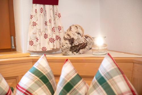 a candle sitting on top of a bed with a pillow at Chalet Innertal in Inneralpbach