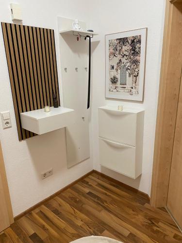 a bathroom with a toilet and a sink at Ferienwohnung Delja in Aulendorf