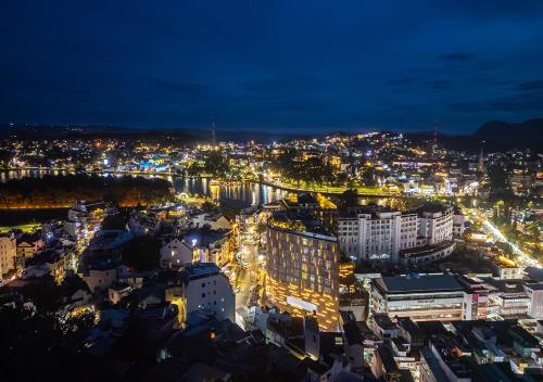 a view of a city at night with lights at Nature Hotel - Win Happy in Da Lat