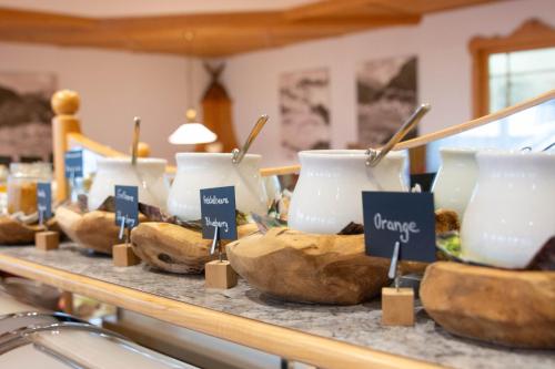a display of bowls of food on a counter at Hotel Garni Alpenhof in Ischgl