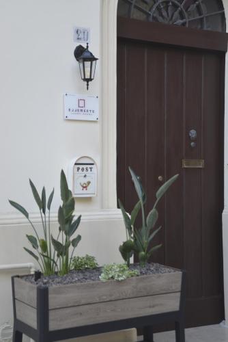 a wooden table with plants in front of a door at ELLEMENTS - Luxury Rooms in Brindisi