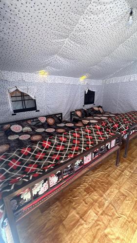 a room with a bunch of donuts on a bed at Adiyogi Campsite in Sari