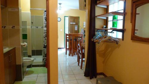 a bathroom with a shower and a kitchen with a toilet at Lodge Takini 4 in Kourou