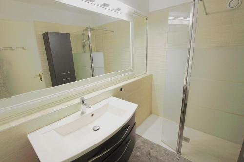 une salle de bain blanche avec un lavabo et une douche dans l'établissement Cannes Palm Beach - Fully fitted apartment - 2 bedrooms, à Cannes
