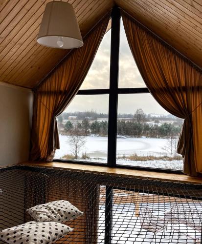 a window in a room with a view of a snowy field at Domki Fajnie.Tu in Łączna