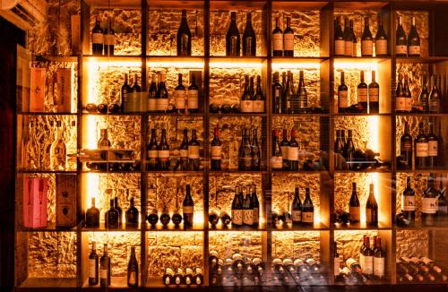 a wall filled with lots of bottles of alcohol at SWISS MORAIRA HOTEL & SPA - Adults only in Moraira