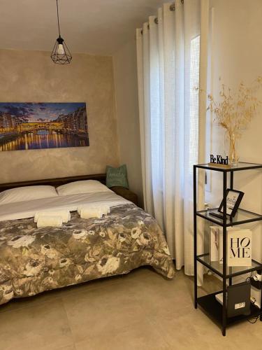 a bedroom with a bed and a painting on the wall at MagicFlo Santa Croce Appartamento in Florence