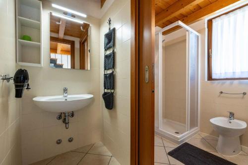a bathroom with a sink and a toilet and a shower at Apartments in Tremosine - Gardasee 22254 in Pieve