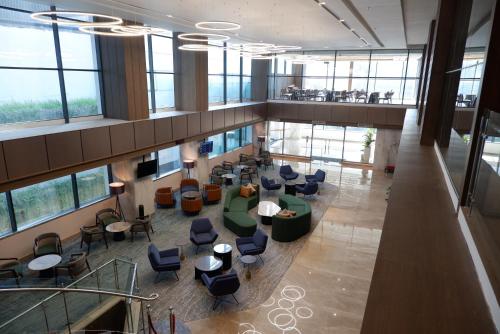 an overhead view of a lobby with chairs and tables at Grand Anara Airport Hotel in Tangerang