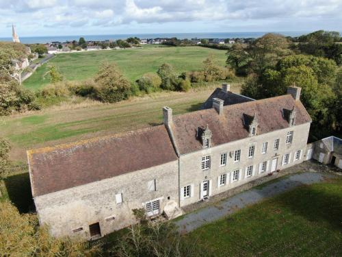 an aerial view of an old house in a field at Manoir de l’Ormel Omaha Beach in Vierville-sur-Mer