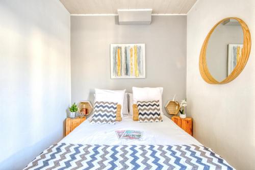a bedroom with a bed and a mirror at Sur La Route Des Vins - Libourne in Libourne