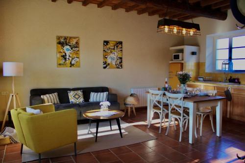 a living room with a couch and a table at Mas de l'Hermitage in Moulès