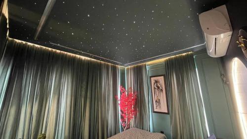 a bedroom with a starry ceiling and curtains at Luxury Elite Apartment with Exclusive Views in Lahore