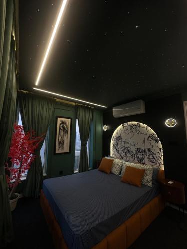 a bedroom with a bed with a star ceiling at Luxury Elite Apartment with Exclusive Views in Lahore