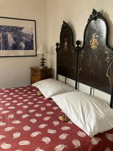 a bedroom with a bed with a large headboard at Casa Didun -apart Bartume' in Dolcedo