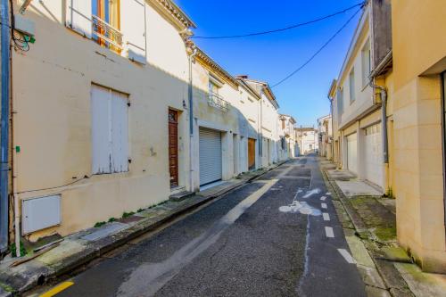 an empty street in an alley with buildings at Sur La Route Des Vins - Libourne in Libourne
