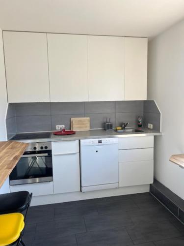 a kitchen with white cabinets and a sink at Haus 6-16P - 6Zi - Aurora Hamburg in Buchholz in der Nordheide