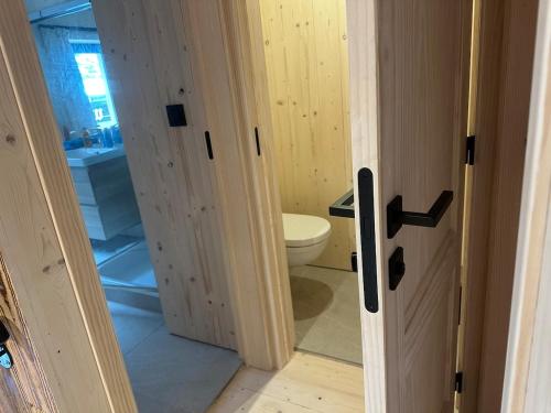 an open door to a bathroom with a toilet at Le Randonneur charmful chalet near Zermatt 6 to 12p in Täsch
