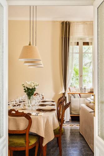 a dining room with a table with a white table cloth at Villa Angela Maria - Brienno by LoveComo in Brienno