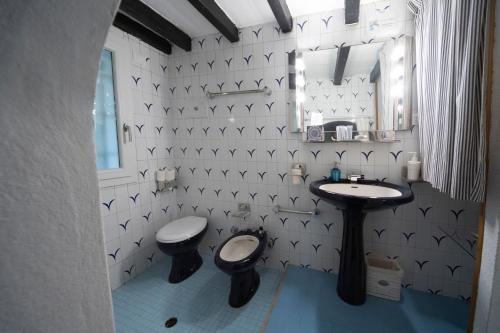 a bathroom with a toilet and a sink at Parma, Antico Studio dietro al Battistero in Parma
