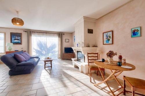 un salon avec un canapé bleu et une table dans l'établissement La Couarde sur Mer, maison pour 6 personnes, à La Couarde-sur-Mer