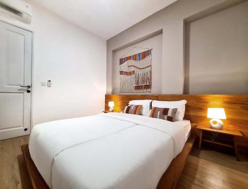 Postel nebo postele na pokoji v ubytování Ocean Beach Villas - Carita Kondominium