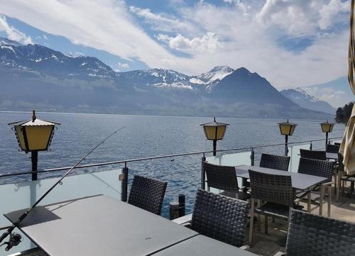 a restaurant with tables and chairs and a view of the water at Boutique Hotel Fähri Gersau in Gersau