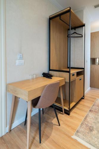 a wooden table and a chair in a room at MERKO HOTEL in Berat