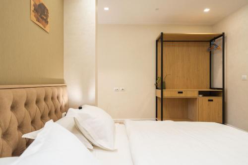 a bedroom with two white pillows on a bed at MERKO HOTEL in Berat