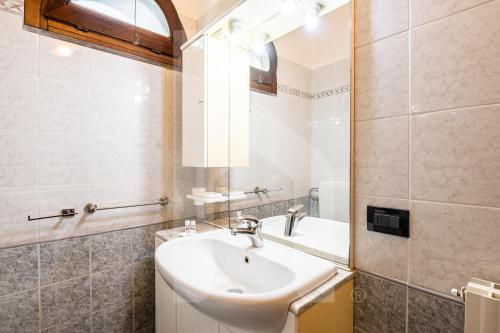 a bathroom with a sink and a mirror at Homiday - Tuscany House - Parcheggio e Giardino Privato in Pisa