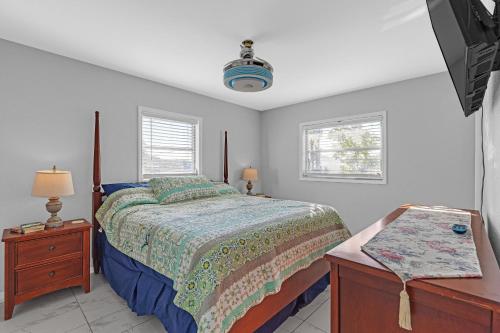 a bedroom with a bed and a dresser and a tv at Waterfront Retreat with Canal Access home in Inverness