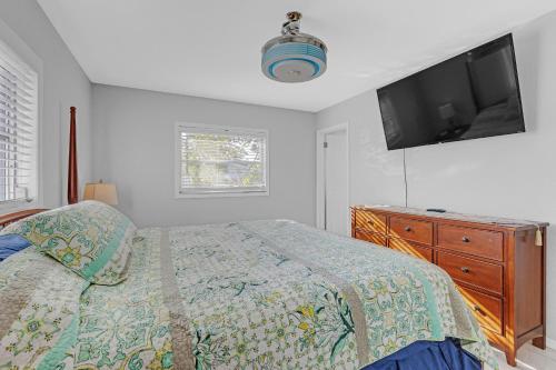 a bedroom with a bed and a tv on the wall at Waterfront Retreat with Canal Access home in Inverness