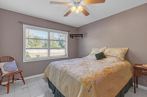 a bedroom with a bed and a ceiling fan at Waterfront Retreat with Canal Access home in Inverness