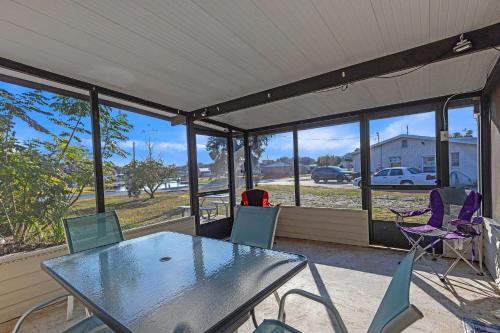 a screened in porch with a table and chairs at Waterfront Retreat with Canal Access home in Inverness
