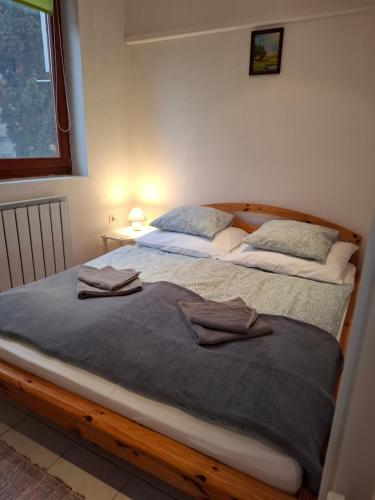 a bedroom with two beds with towels on them at Emma vendégház in Sárospatak
