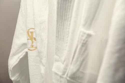 a close up of a white shirt with a gold belt at Hotel Dirista in Shkodër