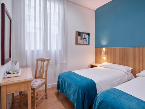 Postel nebo postele na pokoji v ubytování Hostal Bianco
