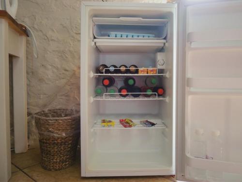 an open refrigerator with food and drinks in it at Barn Guesthouse in Kroonstad