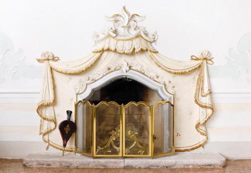 a gold and white fireplace in a room at Villa il Galero in Asolo