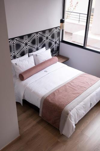 a bedroom with a large bed with a large window at Citrus Daliani Rooms in Chania