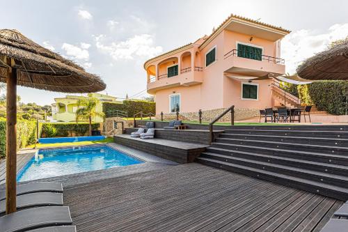 a villa with a swimming pool and a house at Villa Arade Riverside - Jacuzzi and Heated Pool by AlgarStays in Silves