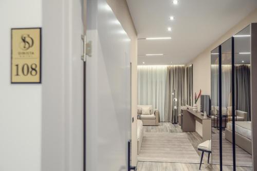 a hotel room with a bedroom and a living room at Hotel Dirista in Shkodër