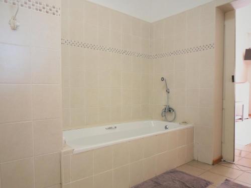 a bathroom with a bath tub in a room at Barn Guesthouse in Kroonstad