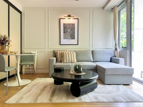 a living room with a couch and a table at Collins Escape - 2 bedrooms with Collins St Balcony in Melbourne