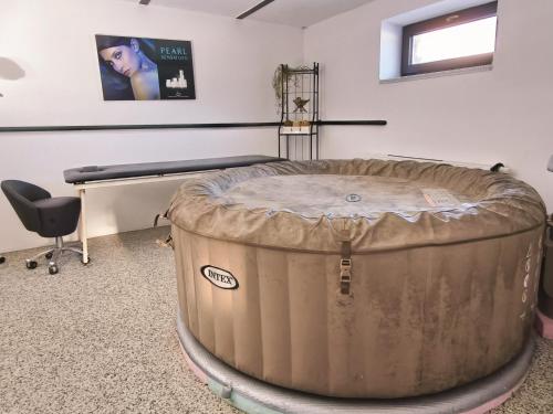 a massage room with a large barrel in the middle at JOSEFAC Family & Friends Villa in Josefuv dul