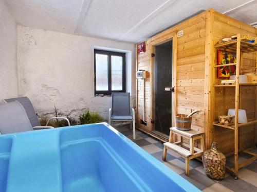 a bathroom with a blue tub in a room at JOSEFAC Family & Friends Villa in Josefuv dul