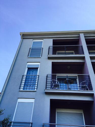 a tall building with balconies on the side of it at Apartment Mirella in Umag
