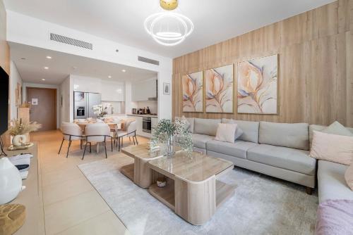 a living room with a couch and a table at Amazing 2BR Home Burj Khalifa View Steps Walk to DubaiMall in Dubai